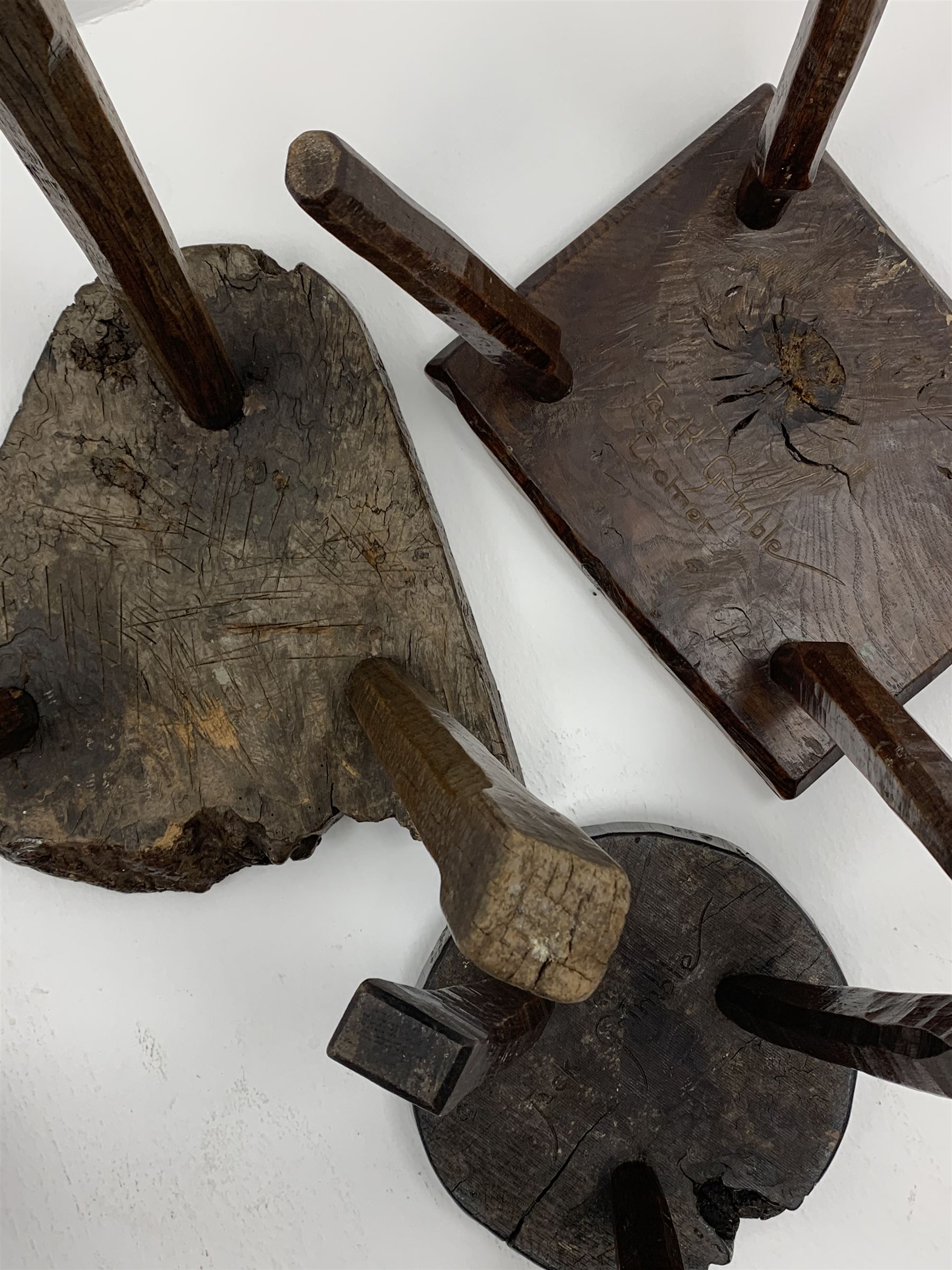 Collection of three mid 20th century stools by Jack Grimble of Cromer - rectangular tooled oak seat on four splayed supports (38cm x 31cm, H35cm), circular tooled burr oak seat on three supports (D29cm, H35cm), shaped burr top on three supports (L44cm, H45cm), each signed underneath