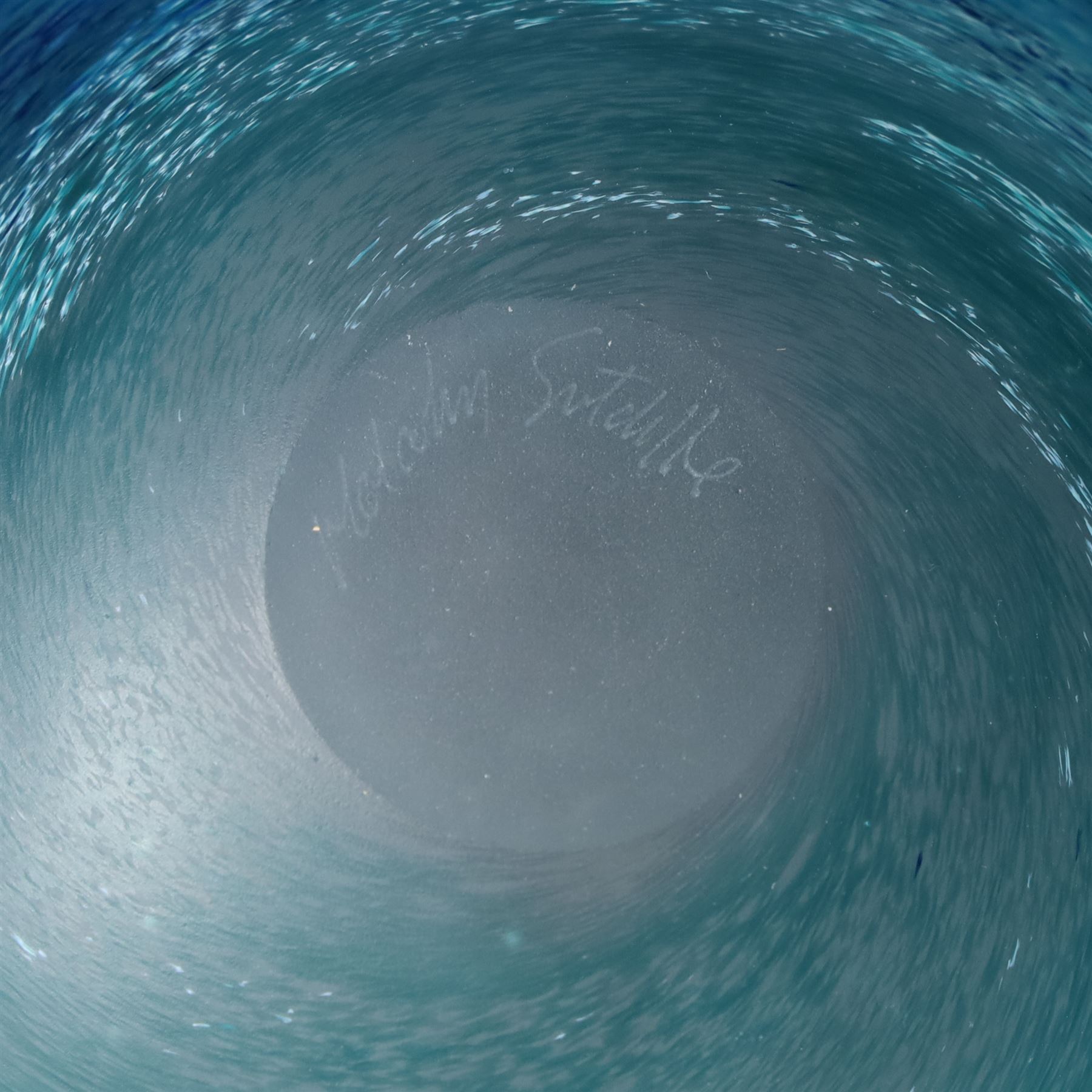 Malcolm Sutcliffe (British 1954-): Studio glass cameo bowl, the body mottled and speckled with shades of blue decorated with dolphins, etched signature, D18cm and matching paperweight (2)
