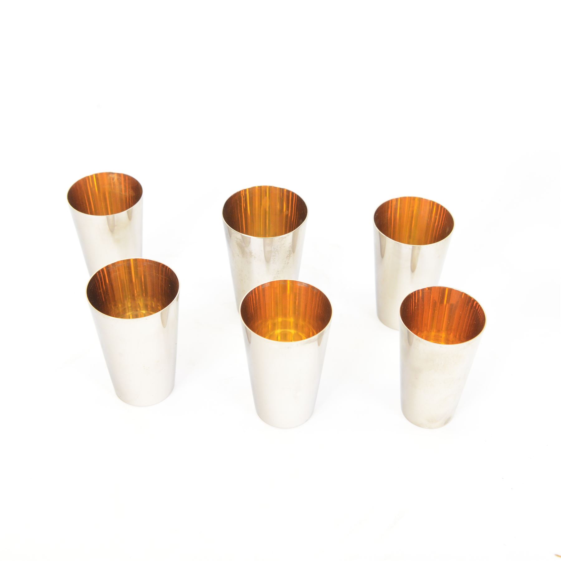 Asprey silver plated stirrup cup, engraved with name to body, together with a set of graduating silver plated stirrup cups, both in leather cases