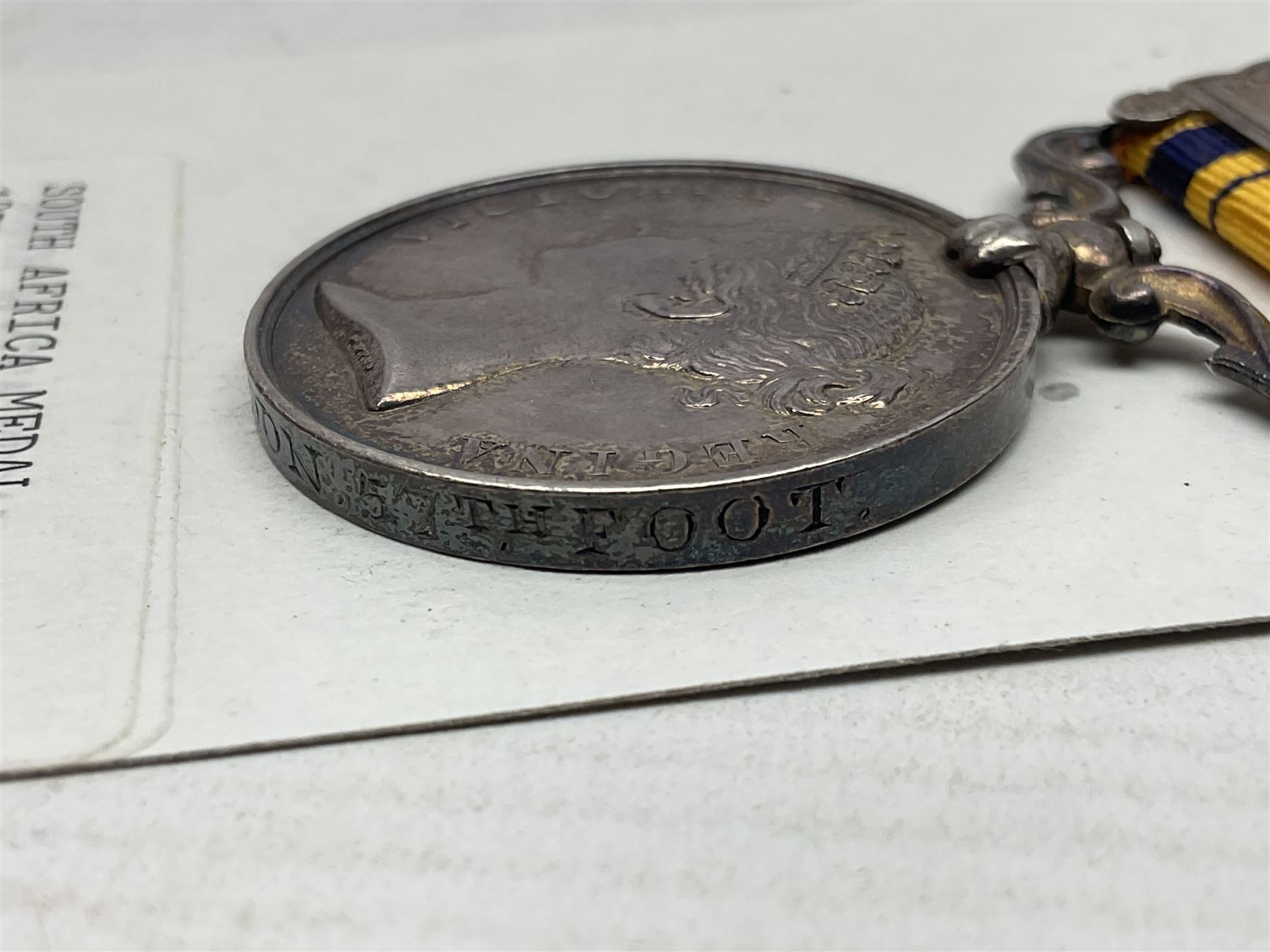 Victoria South Africa Medal (Zulu Wars) 1877-79 with 1879 clasp awarded to 50/544 Pte. T. Noon 57th Foot (West Middlesex regiment); with replacement ribbon but original ribbon present