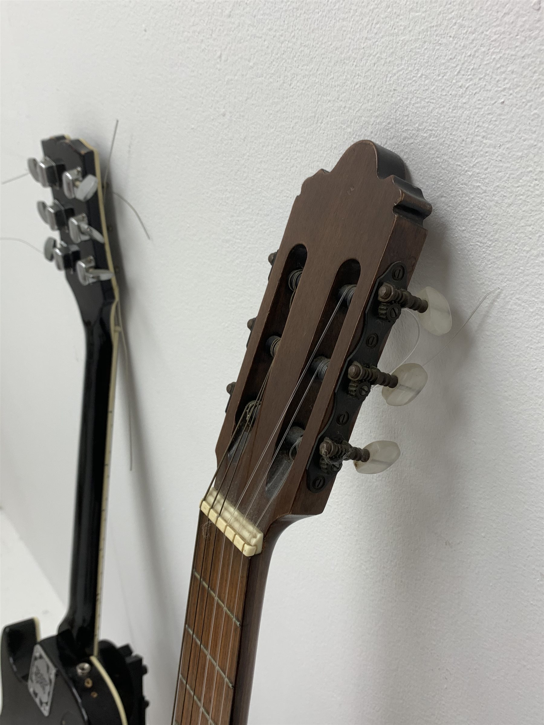 Hohner Arbor Series electric guitar in black and elm effect, serial no.E714703, L101cm; together with an acoustic guitar L102cm; with two Kinsman folding stands (4)