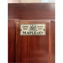 Maple and Co - Edwardian Hepplewhite design white painted triple wardrobe, foliate carved projecting cornice over ribbon and husk swag decorated frieze, two curtain lined astragal glazed doors and centre full mirror door, fitted mahogany interior including slides and drawers, plinth base, label to top of central door