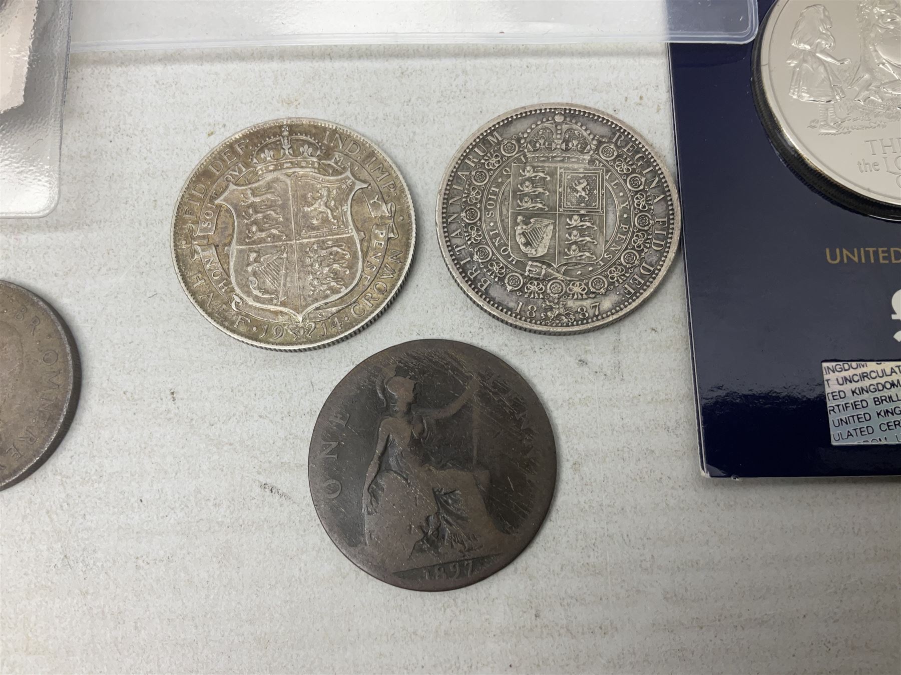 Coins and sets, including Great Britain and Northern Ireland 1970 proof coin collection in card folder, Queen Elizabeth II 2021 'Through the Looking Glass' five pounds, 2021 'Winnie the Pooh' fifty pence, Queen Victoria 1887 halfcrown, King George V 1914 halfcrown, commemorative coins, The Royal Mint Solomon Islands 2003 twenty-five dollars silver proof coin cased with certificate, 9ct gold half sovereign mount etc