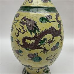 20th century Chinese Famille Verte vase, of slender ovoid form with tapering neck and flared rim, decorated with green and grey enamel with dragons chasing flaming pearls amongst auspicious clouds upon a yellow ground, H30cm