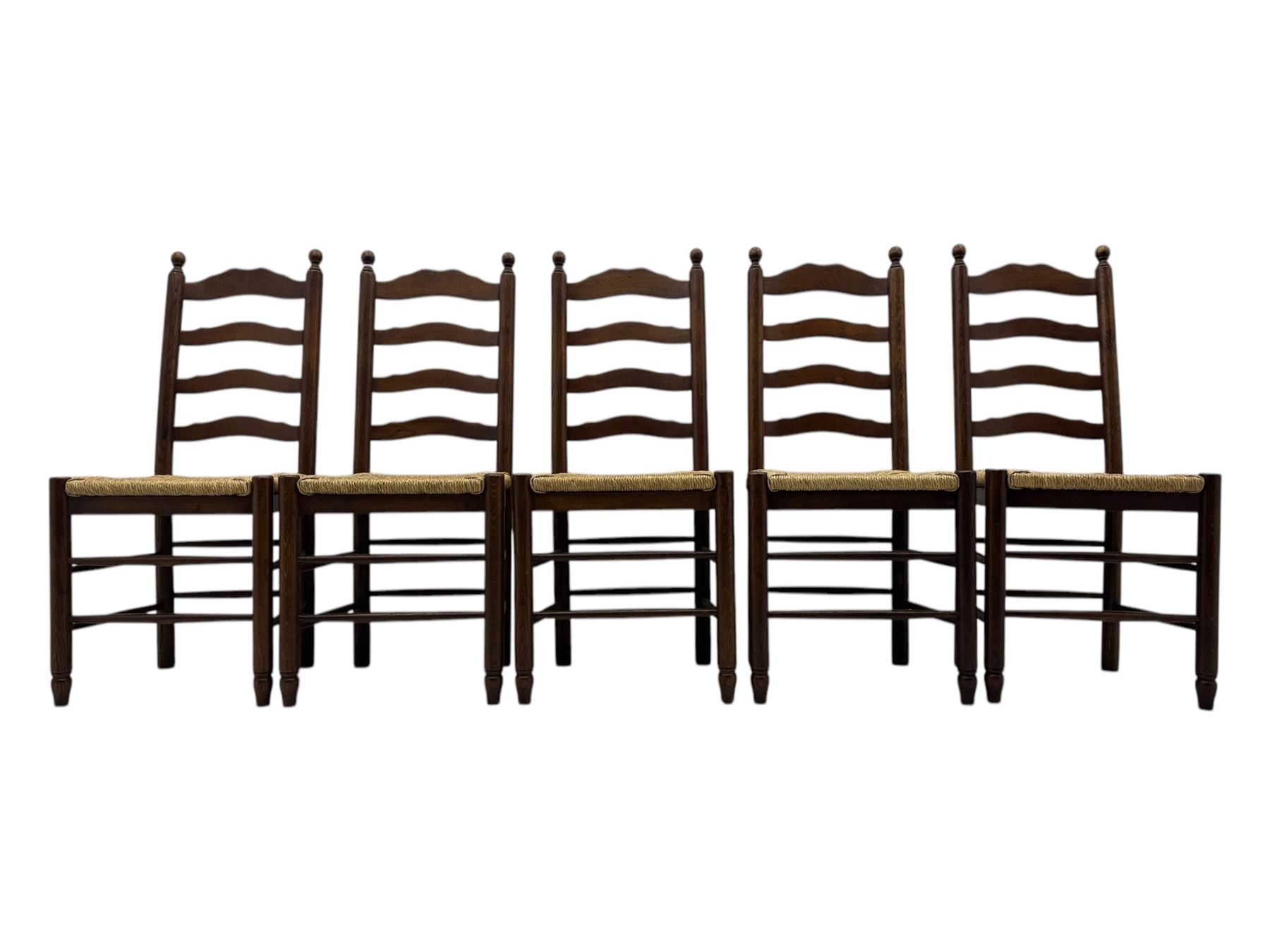 Set of ten 18th century design oak ladder back dining chairs, shaped cresting rail over four horizontal splats, rush seat raised on turned supports united by double stretchers