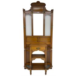 Edwardian oak hall stand, pediment carved with shell and gadroon decoration over reeded and dentil design, rectangular bevelled mirror back surrounded by brass coat hooks, fitted with single drawer flanked by umbrella stands and drip trays