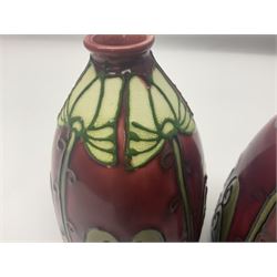 Pair Minton secessionist vases, designed by Leon Solon and John Wadsworth, of ovoid form with everted rim, with tube-lined stylised flower head decoration on a red ground, with printed mark beneath Minton Ltd, No. 30, H13cm