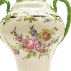 Pair of Dresden lidded vases with twin handles, decorated with flowering sprigs and a foliate boarder, H25cm