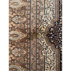 Large Persian indigo ground rug, the busy field decorated with trailing branches and flower heads, peach border decorated with palmettes -