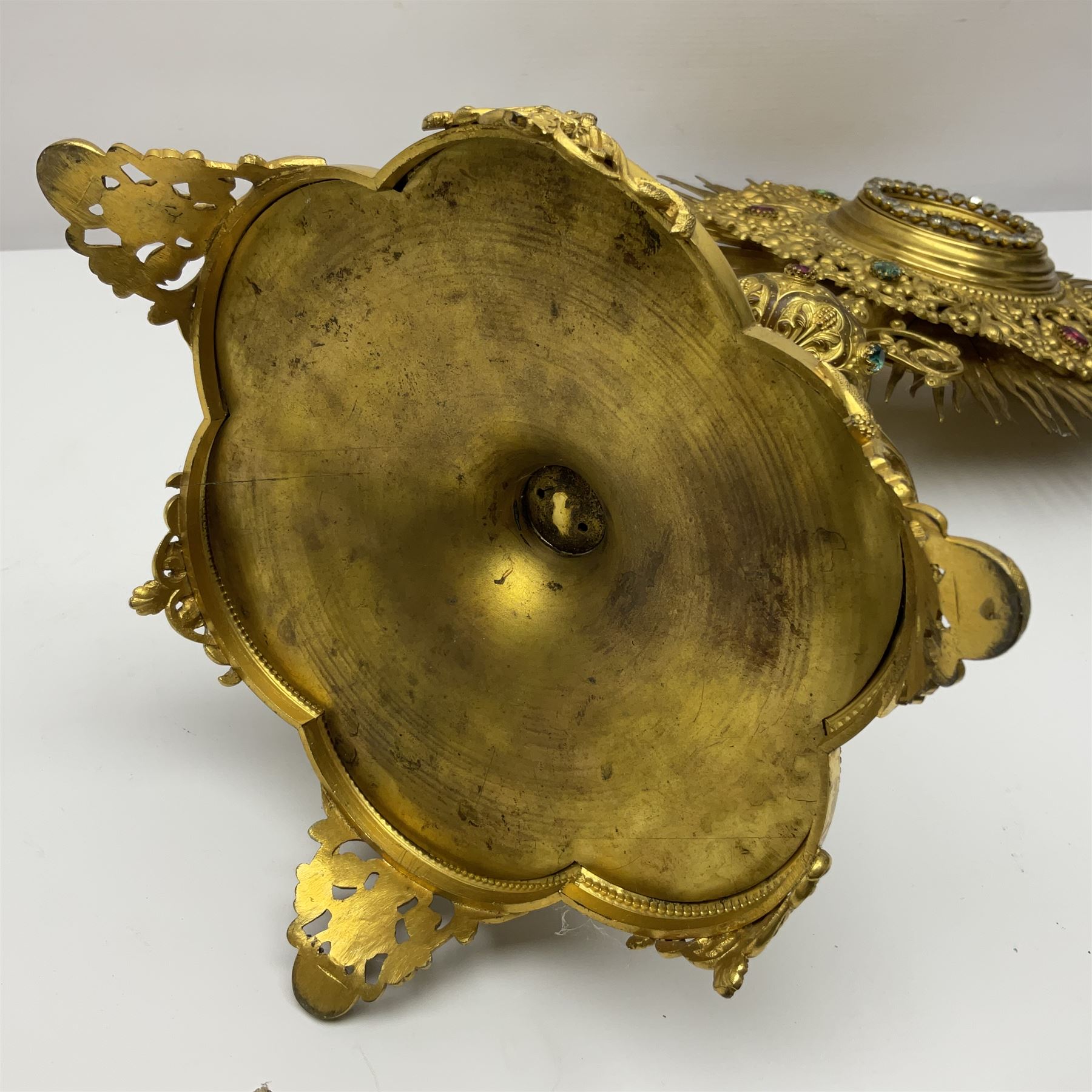 20th century gilt metal monstrance, in the Gothic revival style, with glazed aperture to centre surrounded with clear paste stones, in a pierced floral and scroll border set with coloured paste stones, within a sunburst surround, on a paste set knopped stem and similar foliate foot, H59.3cm