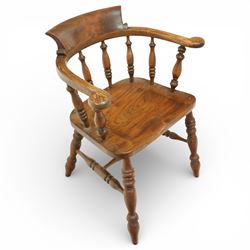 20th century captain’s oak smoker’s chair, with curved horseshoe back rail, turned spindle supports, shaped solid seat, turned legs united by stretchers