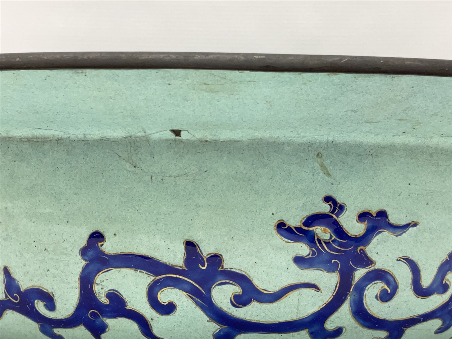 18th/19th century Chinese Canton enamel basin, the circular basin with flat everted rim, decorated with scrolling foliate and fruit decoration on a blue ground, D43cm