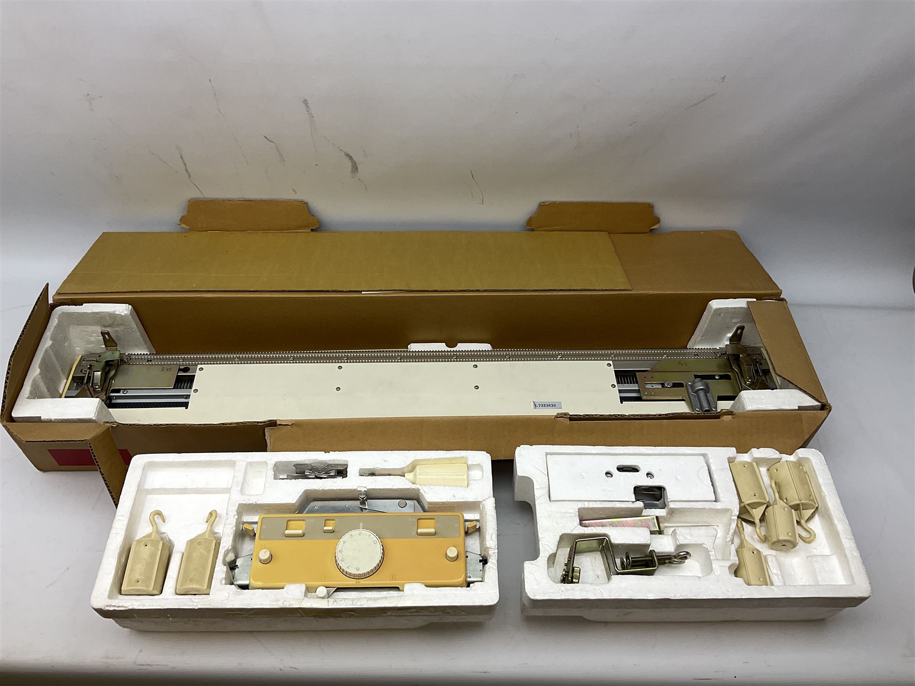  Brother cased knitting machine model KH-890 together with Brother Ribbing attachment model KH-850, knitting machine yarn cones in assorted colours, selection of knitting patterns etc