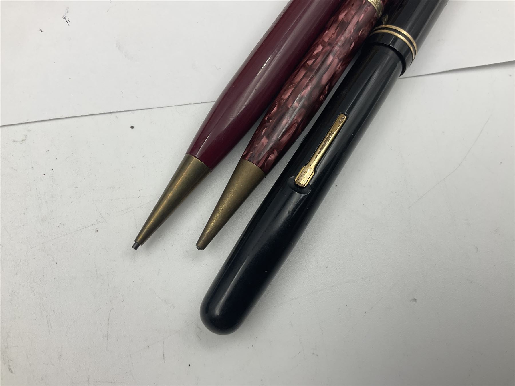 Group of Waterman pens and propelling pencils, to include a fountain pen, the black barrel with rolled gold cap and nib stamped 14ct, together with a matching propelling pencil, in box, together with a further fountain pen with gold nib stamped 14ct, stainless steel fountain pen and rollerball set in box, propelling pencil with maroon barrel etc, largest L13cm (7)