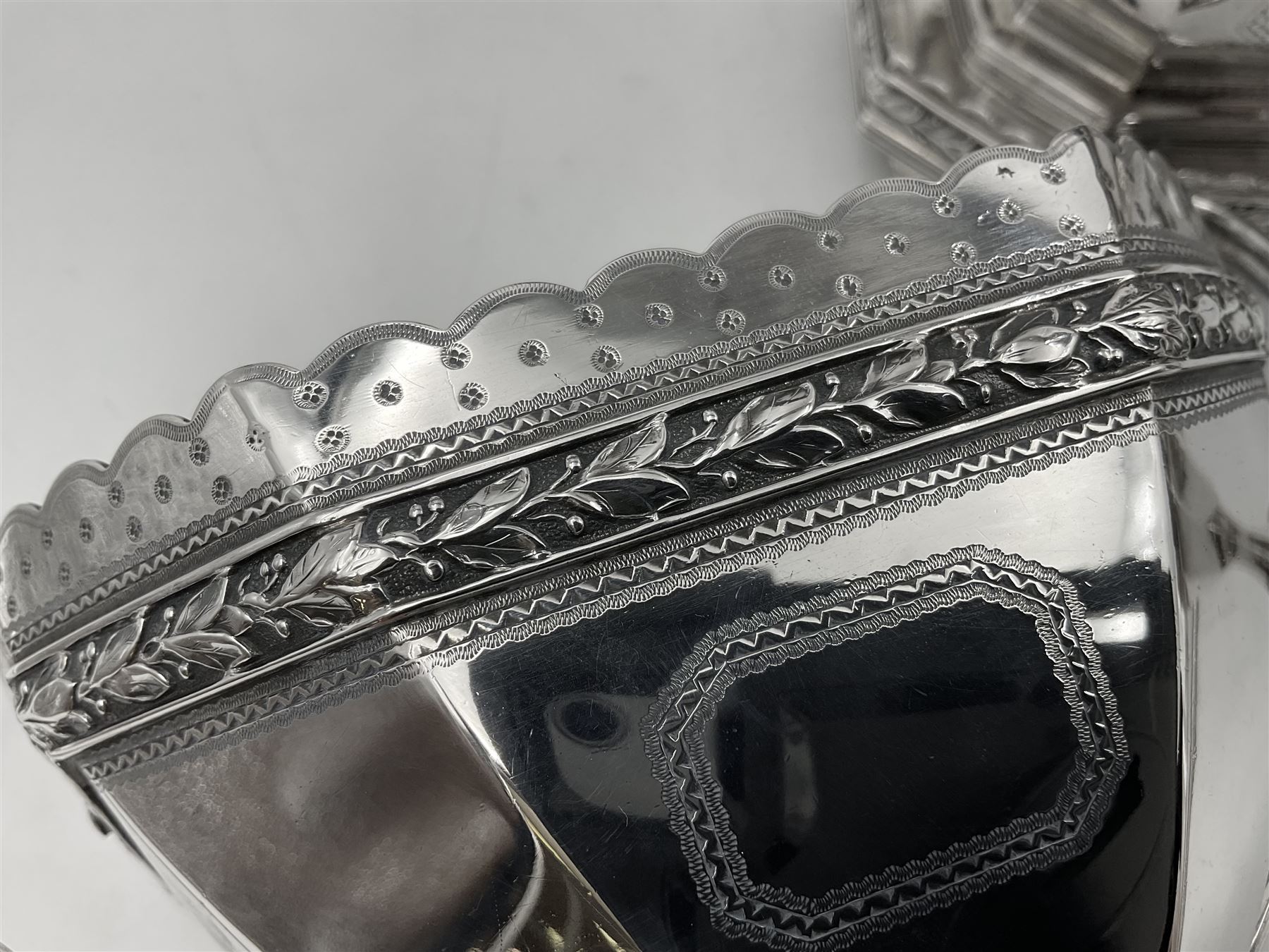 Victorian silver four piece tea service, comprising teapot, teapot stand, twin handled open sucrier and milk jug, each of octagonal form with foliate bud border and engraved decoration including crest to canted panels, and vacant panels, the teapot with ivory finial to the hinged cover and later wooden handle, hallmarked Edward Barnard & Sons Ltd, London1896, teapot including finial H15cm, milk jug including handle H16cm, teapot stand W11.5cm

This item has been registered for sale under Section 10 of the APHA Ivory Act