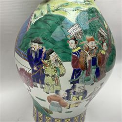 20th century Chinese Famille Rose vase, of baluster form with flared lobed rim and twin figural handles, decorated in polychrome enamel with figures dancing and playing instruments within a garden setting, H42cm