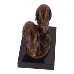 Bronze figure group, modelled two hares in chase, upon naturalistically modelled oval base signed Nick and with foundry mark, raised upon black marble base, H11cm L12.5cm