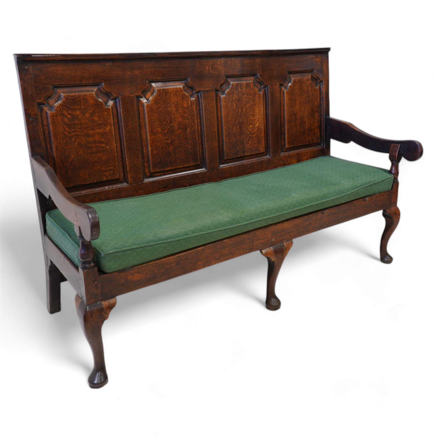 18th century oak settle or hall bench, moulded cresting rail over quadruple fielded panelled back, shaped arms over loose squab cushion upholstered in patterned teal fabric, plain frieze rail over cabriole front supports
