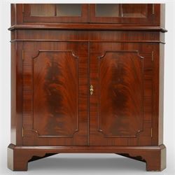 William Tillman - Early 20th century mahogany corner cabinet, the projecting moulded cornice with dentil detail over a glazed upper section enclosed by a pair of astragal glazed doors with Gothic arched tracery, the interior fitted with shaped shelves, above a moulded waist and a lower cupboard enclosed by two panelled doors with shaped fielded panels, raised on bracket feet