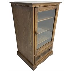 Ercol - mid-20th century dark elm 'Old Colonial' music cabinet, single glazed door enclosing three shelves, single drawer fitted to base