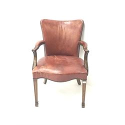 Early 20th century mahogany framed elbow chair upholstered in studded red leather with serpentine seat, square tapering supports on spade feet