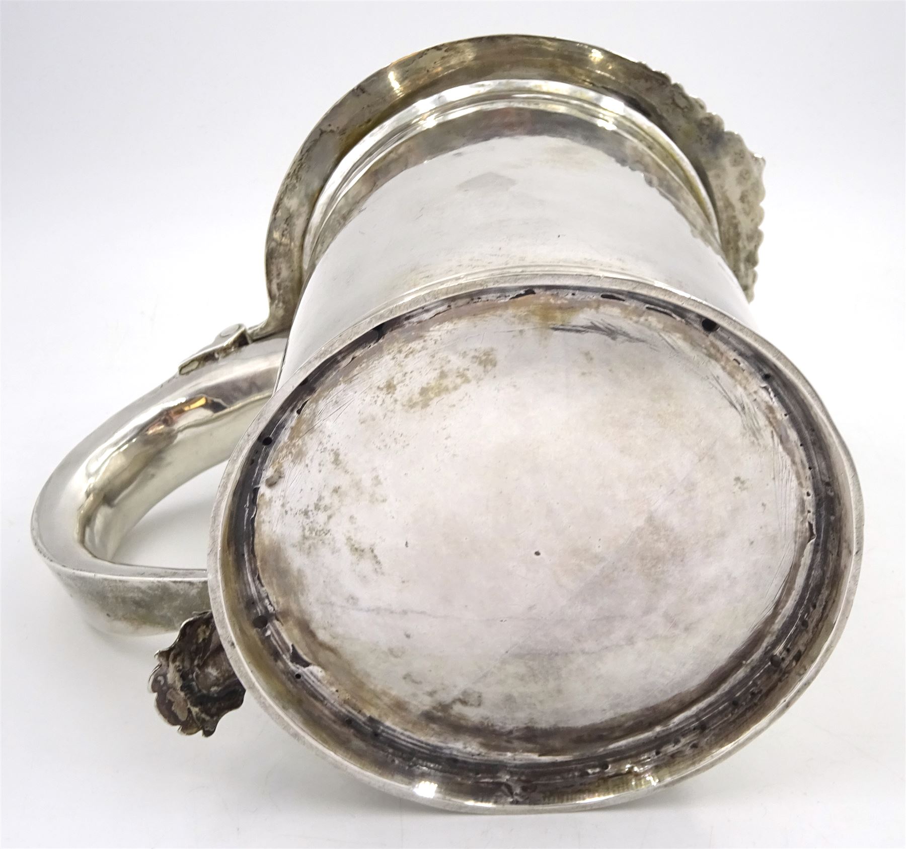 Queen Anne silver tankard, of plain tapering cylindrical form, with stepped and flat-domed cover, twit cast thumbpiece and curved handle, the body engraved with eagle crest, hallmarked Abraham Barachin, Hull, circa 1706, the body and cover stamped once with makers mark and twice with town mark, H18cm, approximate weight 21.46 ozt (667.7 grams)
