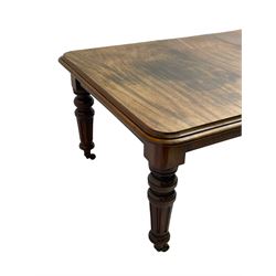 19th century mahogany extending dining table, moulded rectangular top with rounded corners, telescopic winding action, turned and fluted supports on brass castors, two additional leaves