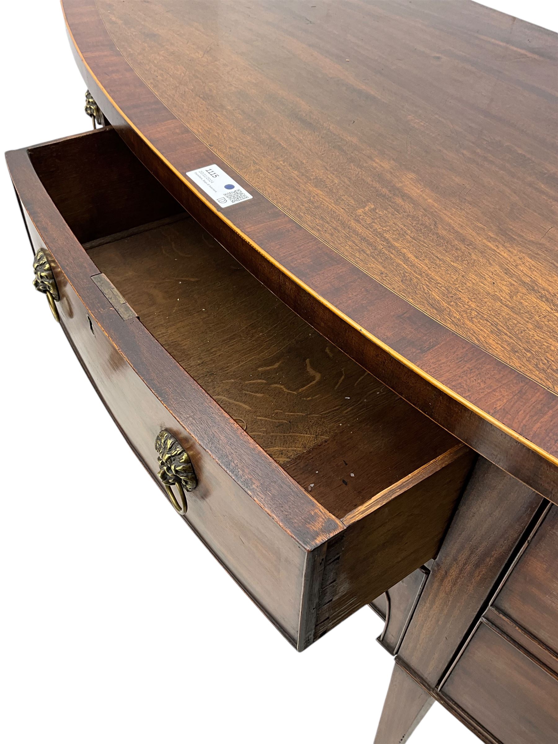 George III mahogany bow-fronted sideboard, mahogany banded top over three drawers and cupboard, fitted with lion mask and hoop handles, on square tapering supports with spade feet