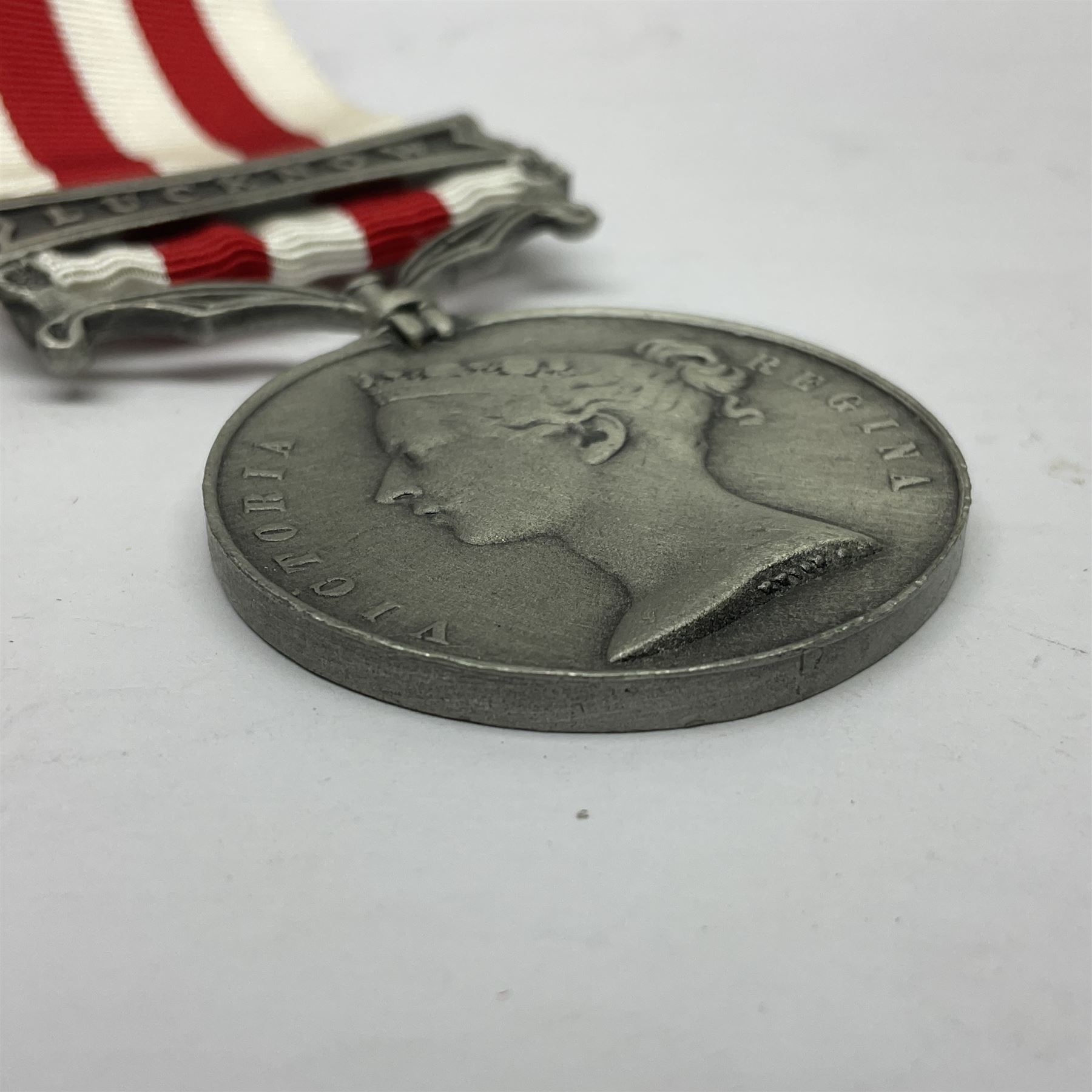 Victoria Long Service in the Volunteer Force Medal awarded to 369 Bombr. W. Woodward 1st Lincs. V.A.; and reproduction Victoria India Medal with Lucknow clasp; both with ribbons (2)