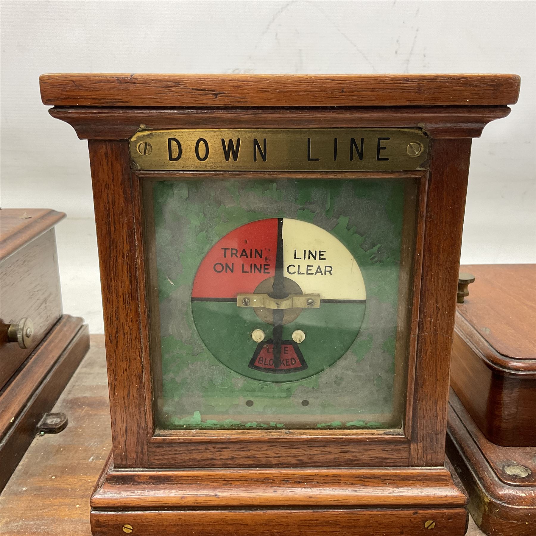 Railway signal boxes, mounted on plinth, with railway block indicators for Up Line and Down Line, having an electromagnetic indicator showing 'Train on Line' 'Line Clear' and 'Line Blocked', and brass signal bell to the centre, L100cm