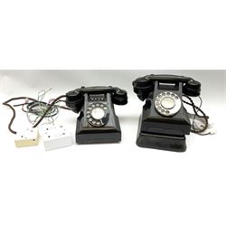 Two vintage black Bakelite telephones, with rotary dials. 
