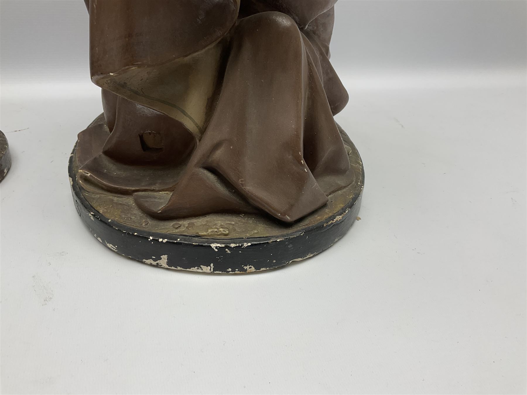 Two religious painted plaster figures of Mary and Joseph kneeling on oval plinths, with impressed mark 'Raffl et Cie Paris', H60cm 