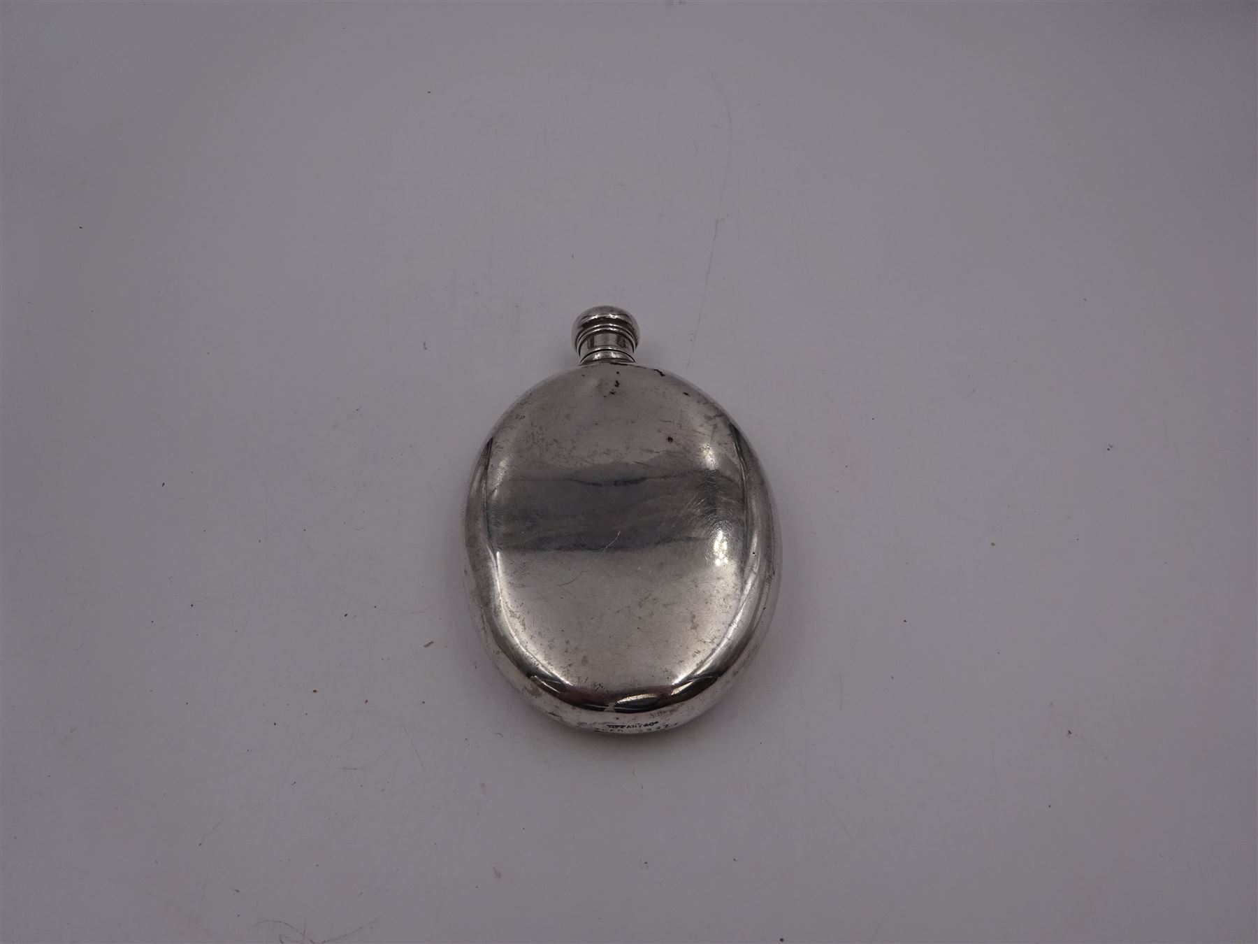 Tiffany & Co silver hip flask, of oval form with screw cap, stamped Tiffany & Co  26503327 Sterling Silver beneath, H11.5cm