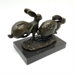 Bronze figure group, modelled as two hares in chase, signed Nick and with foundry mark, upon a rectangular marble base, overall H12cm L16cm
