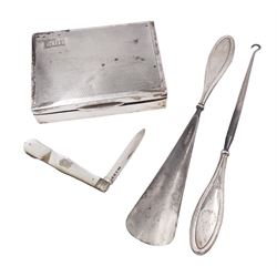 1920s silver mounted cigarette box, of rectangular form, with engraved initials and engine turned decoration to hinged cover, opening to reveal softwood interior, hallmarked E J Trevitt & Sons, Chester 1929, together with a silver handled button hook and shoe horn, and a mother of pearl handled silver fruit knife, all hallmarked, cigarette case W11.5cm, D8.5cm, H3.5cm