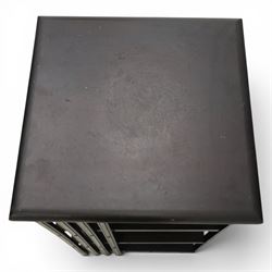 20th century ebonised revolving bookcase, square top with chamfered edges, over a three tier with four sections per tier,  revolving base on castors 