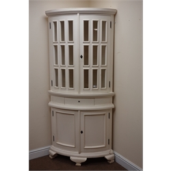  Painted bow fronted floor standing corner cabinet, two glazed doors above single drawer and two cupboard doors, shaped bracket supports, W87cm, H192cm, D59cm  