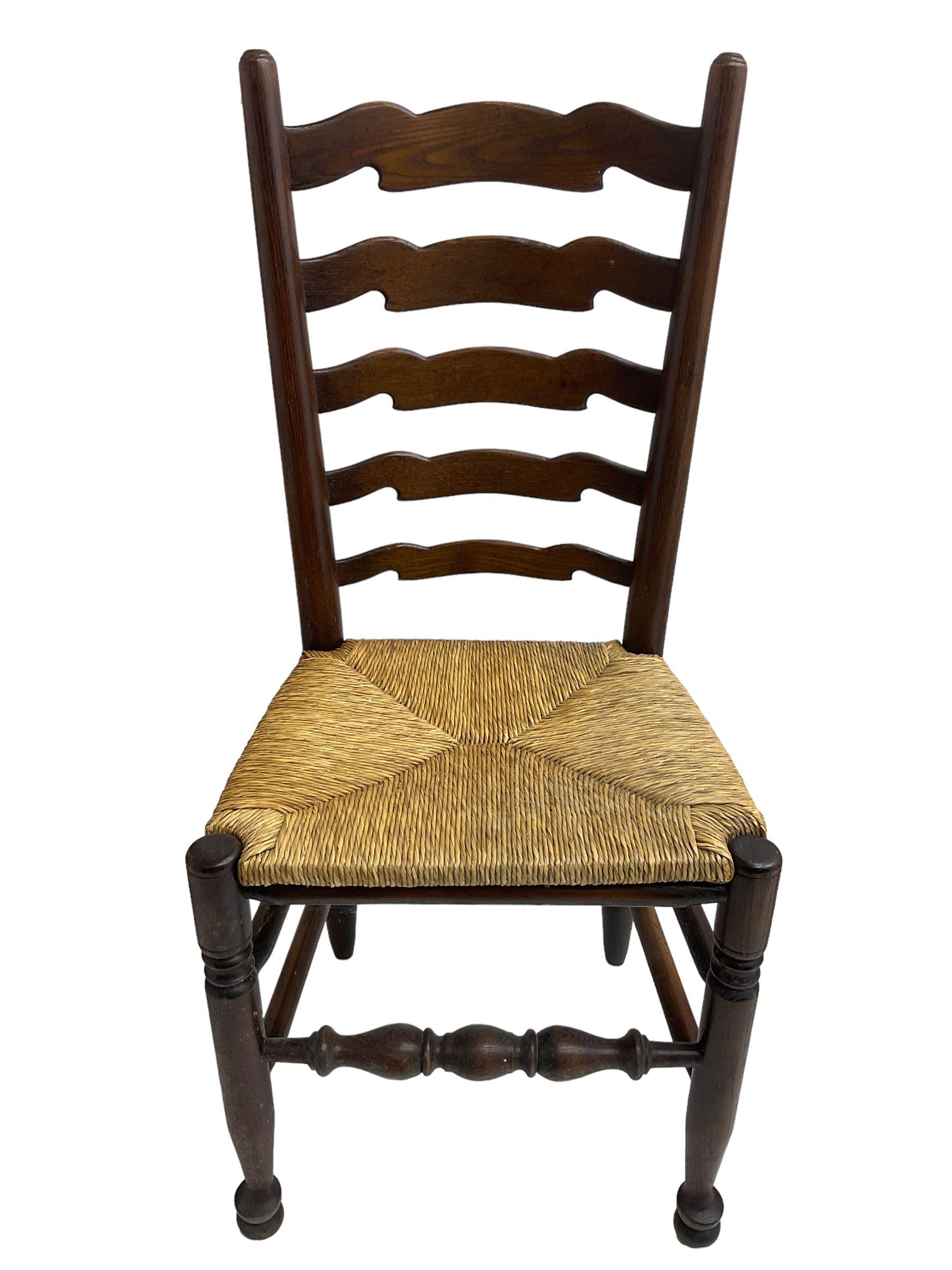 Set eight (6+2) oak dining chairs, high waived ladder back over rush seats, raised on ring turned supports with pad front feet, united by stretchers