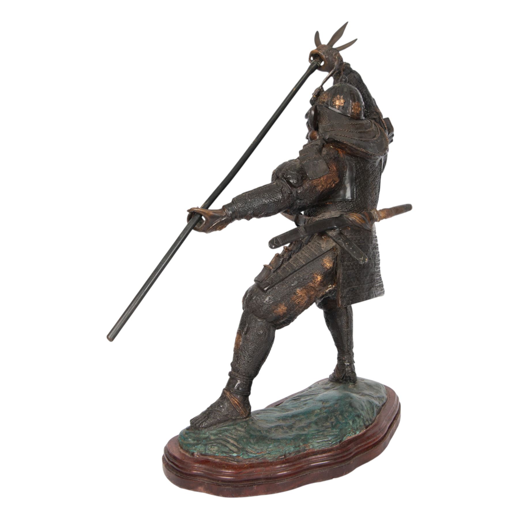 Japanese bronze of a Samurai, possibly Meiji period, standing holding a three pronged spear, on a wave form base, H67cm