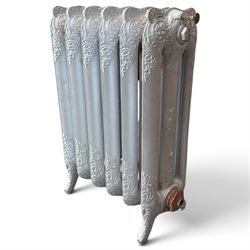 French ornate cast iron column radiator of Rococo Revival design, each section cast with scrolling foliate decoration with rocaille and cartouche motifs, with brass valve and integral bracket feet, in painted silvered finish