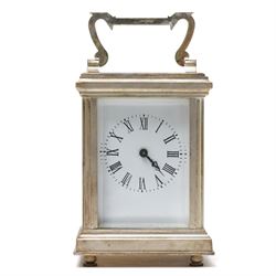 20th century- Silver plated miniature carriage clock in an anglaise case with an enamel dial, Roman numerals, minute track and pieced steel hands, with an oval viewing glass to the lever platform escapement.