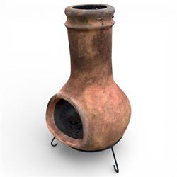 Terracotta chimney patio heater on metal stand