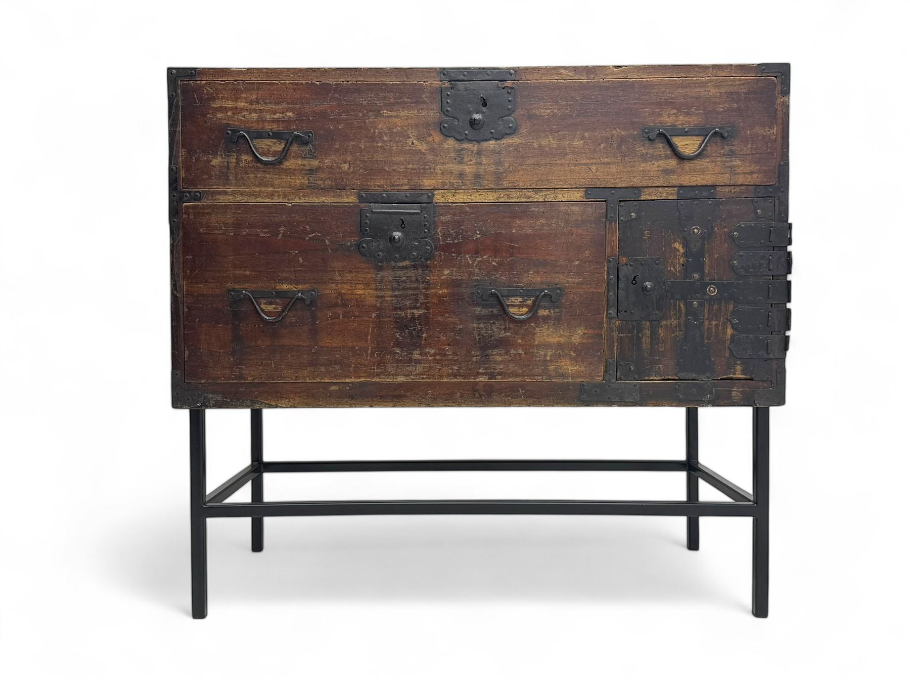 Late 19th century Japanese tansu chest, crafted with a cedar frame and cypress wood panels, original iron fittings throughout, comprising a single long drawer above smaller drawer and hinged cupboard door enclosing two smaller internal drawers and storage compartment, mounted on a bespoke black metal stand