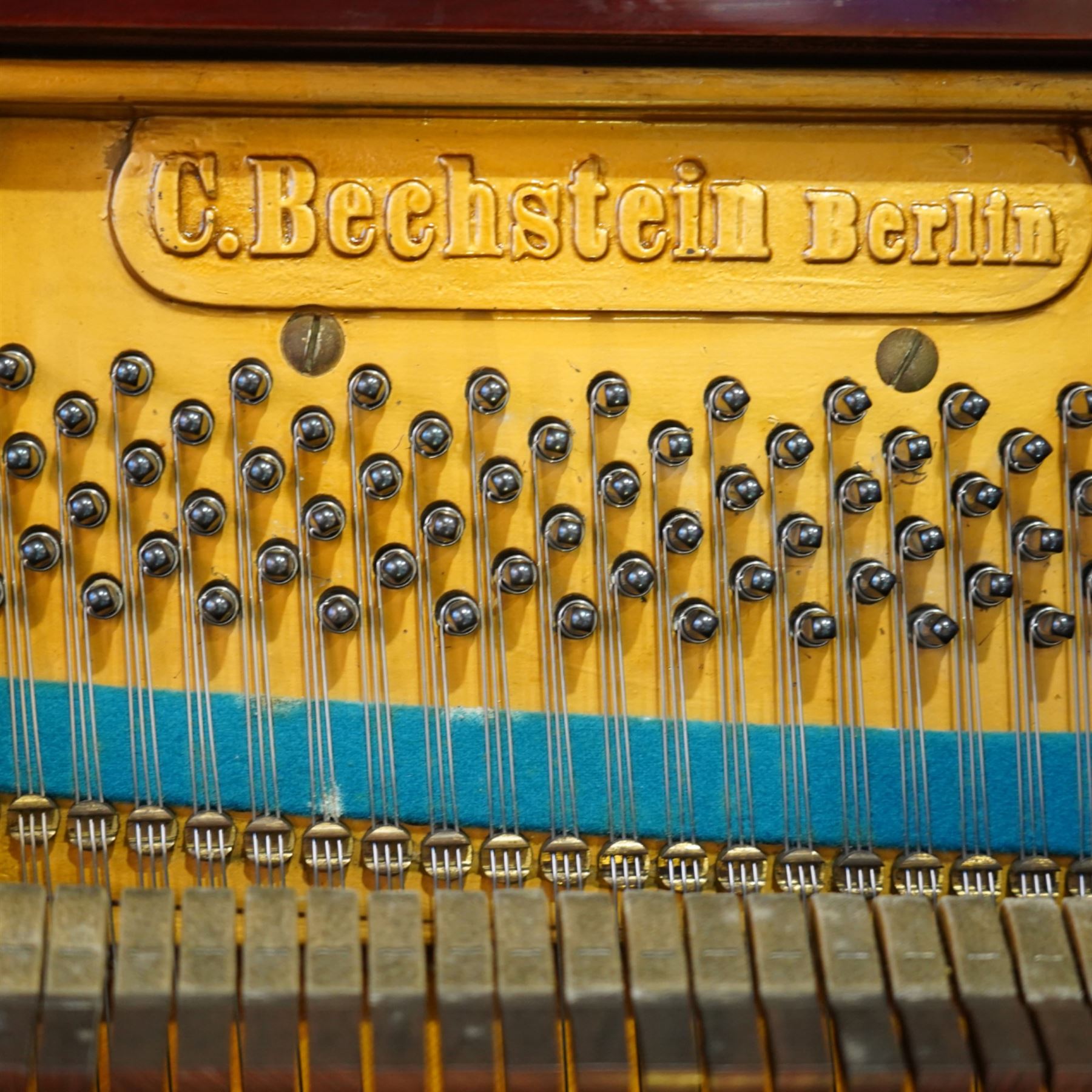 Claud Bechstein- German model IV overstrung upright piano in a mahogany Arts & Crafts designed case by Walter Cave, Serial number 56589 (1900-01), with a lattice music desk and silk backed open fretwork, square key fall with makers name and crafted brass hinges, two candle sconces on tapered square supports, makers name and model number cast into the frame, with an underdamper action, una-corda and sustain pedals, recently re-strung with new tuning pins, responsive action and damping, in very good playing condition, with 85 ivory and ebony keys A0-A7, tuning A=440. Including a period duet stool with a velvet-padded top.
Walter Cave was a leading architect, interior designer, and furniture maker during the Arts & Crafts period, a similar piano to this was owned and played by George Bernard Shaw and is on exhibition at the National Trust property, Shaw's Corner (Hertfordshire).

This item has been registered for sale under section 10 of the APHA Ivory Act, Reference 8P3C9UKA
