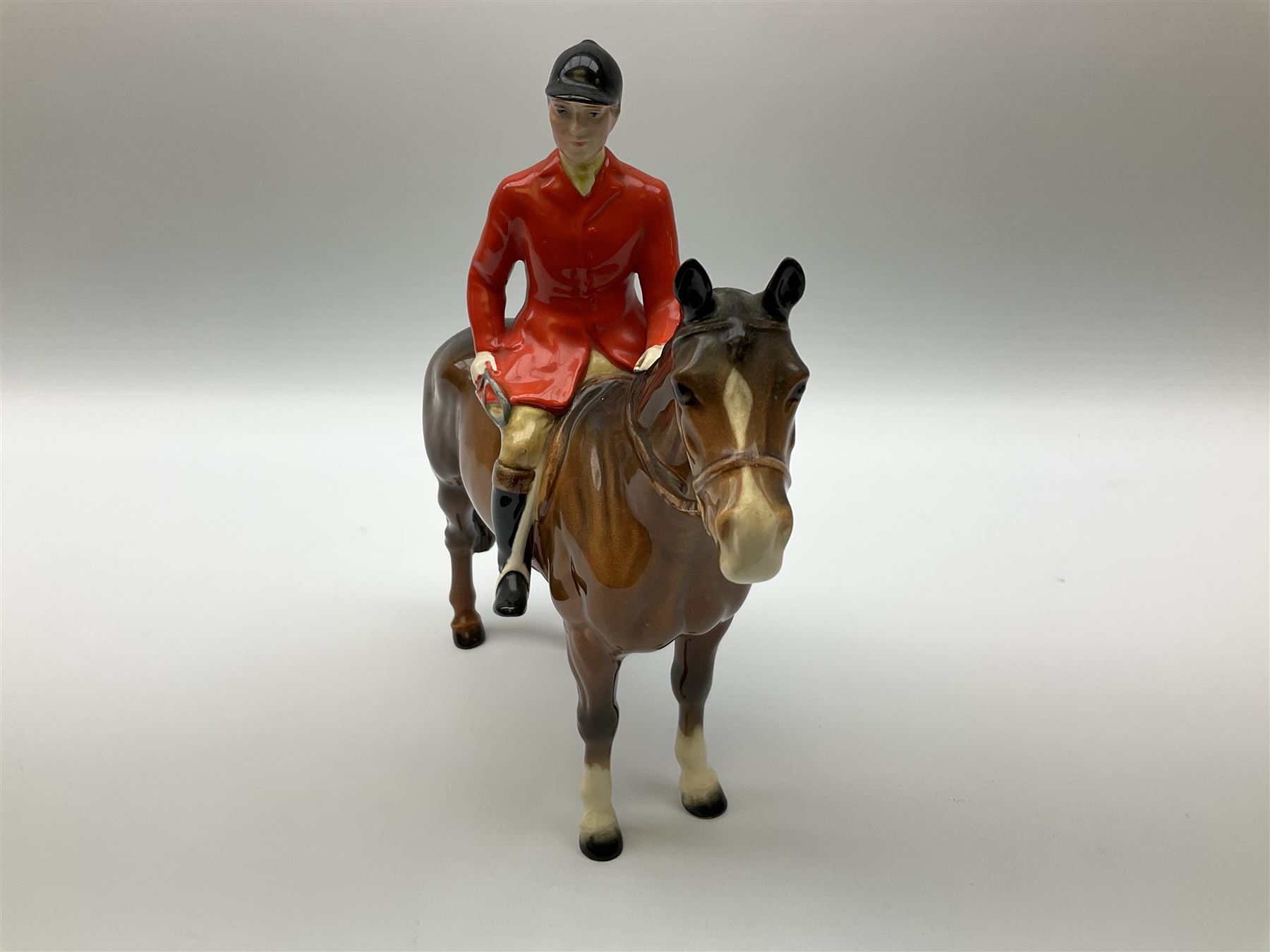 Beswick model of a huntswoman on grey horse model no 1730, and Beswick huntsman on brown horse model no 1501, both with printed mark beneath. 