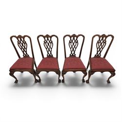 Chippendale design set of ten (8+2) mahogany dining chairs, serpentine cresting rails with carved detail over pierced ribbon-tied splats, red damask upholstered drop-in seats, on cabriole supports with acanthus carved knees and claw and ball feet