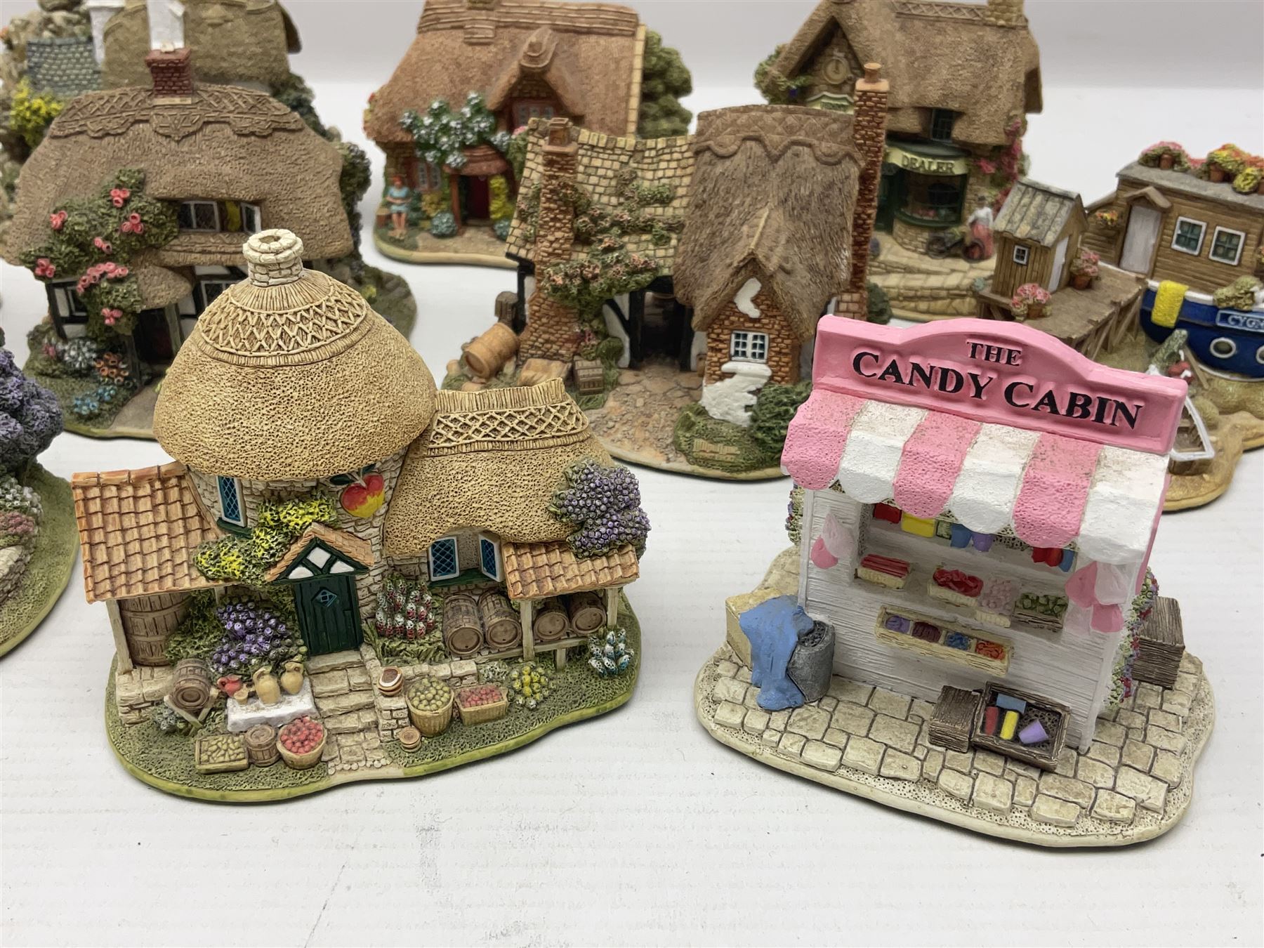 Eighteen Lilliput Lanes, including The Penny Farthing, The Pigsty, Borrowdale School, Fairy Cake Tearoom, An Apple a Day,Ladybird Cottage etc, all with original boxes 
