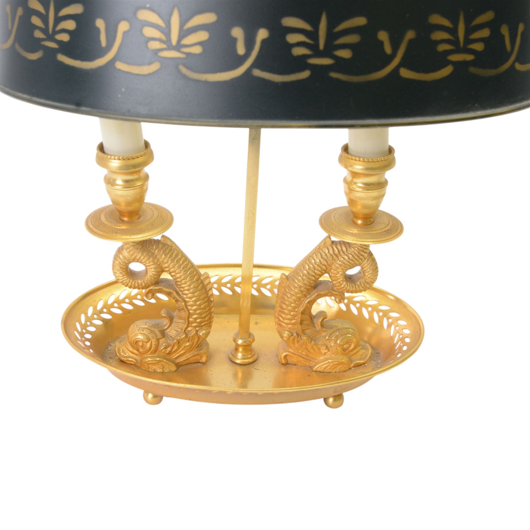 Bouillotte table lamp, designed with two dolphins supporting three faux candle sconces, the adjustable metal shade with arrow fletching form screw, the oval base upon circular pan on four bun feet, H46cm