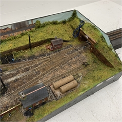 '00' gauge - table top model railway layout with multiple tracks around a central engine shed with other buildings and figures, diorama on three raised sides and open tunnel to one end for further extension, wired for electricity, main layout 104 x 52cm