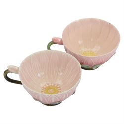 Two Zsolnay Pecs lotus moulded teacups and saucers, with impressed mark beneath
